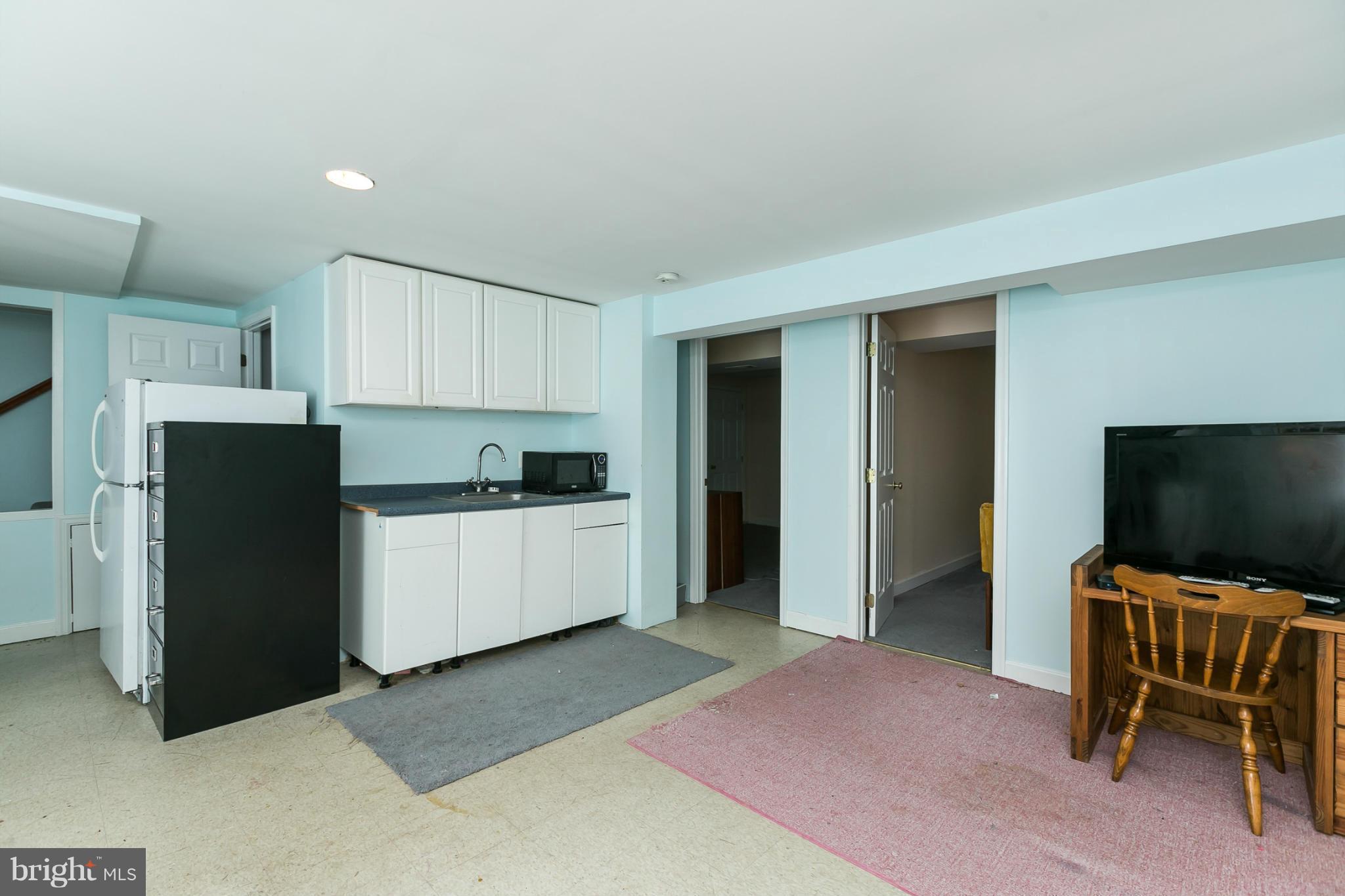 12712 Flack Street Silver Spring, MD 20906 - Photo 21 of 28 a kitchen with a refrigerator and a chair