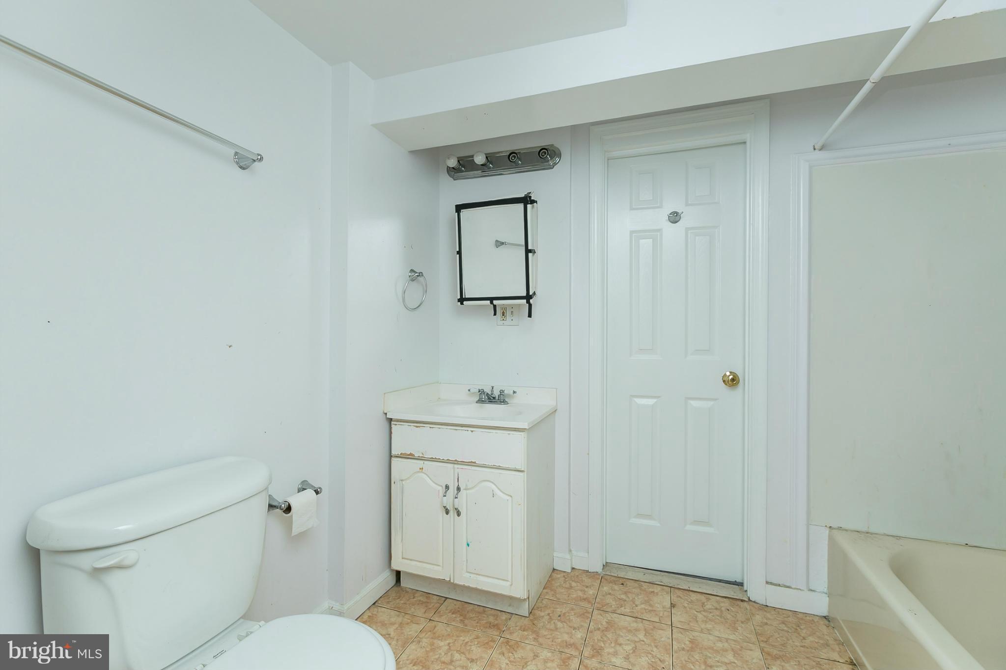 12712 Flack Street Silver Spring, MD 20906 - Photo 25 of 28 a bathroom with a toilet a sink and mirror