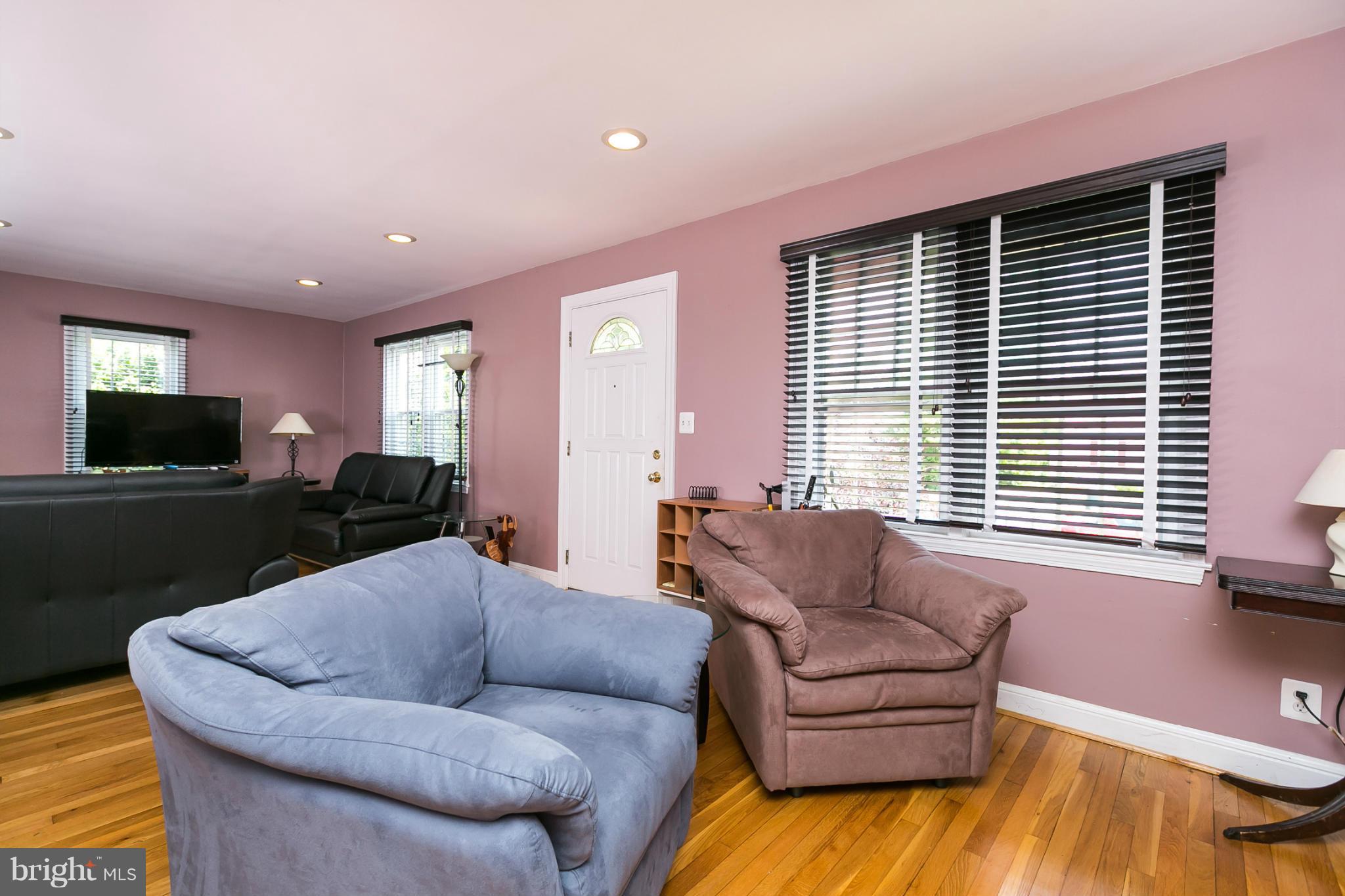 12712 Flack Street Silver Spring, MD 20906 - Photo 4 of 28 a living room with furniture and a flat screen tv