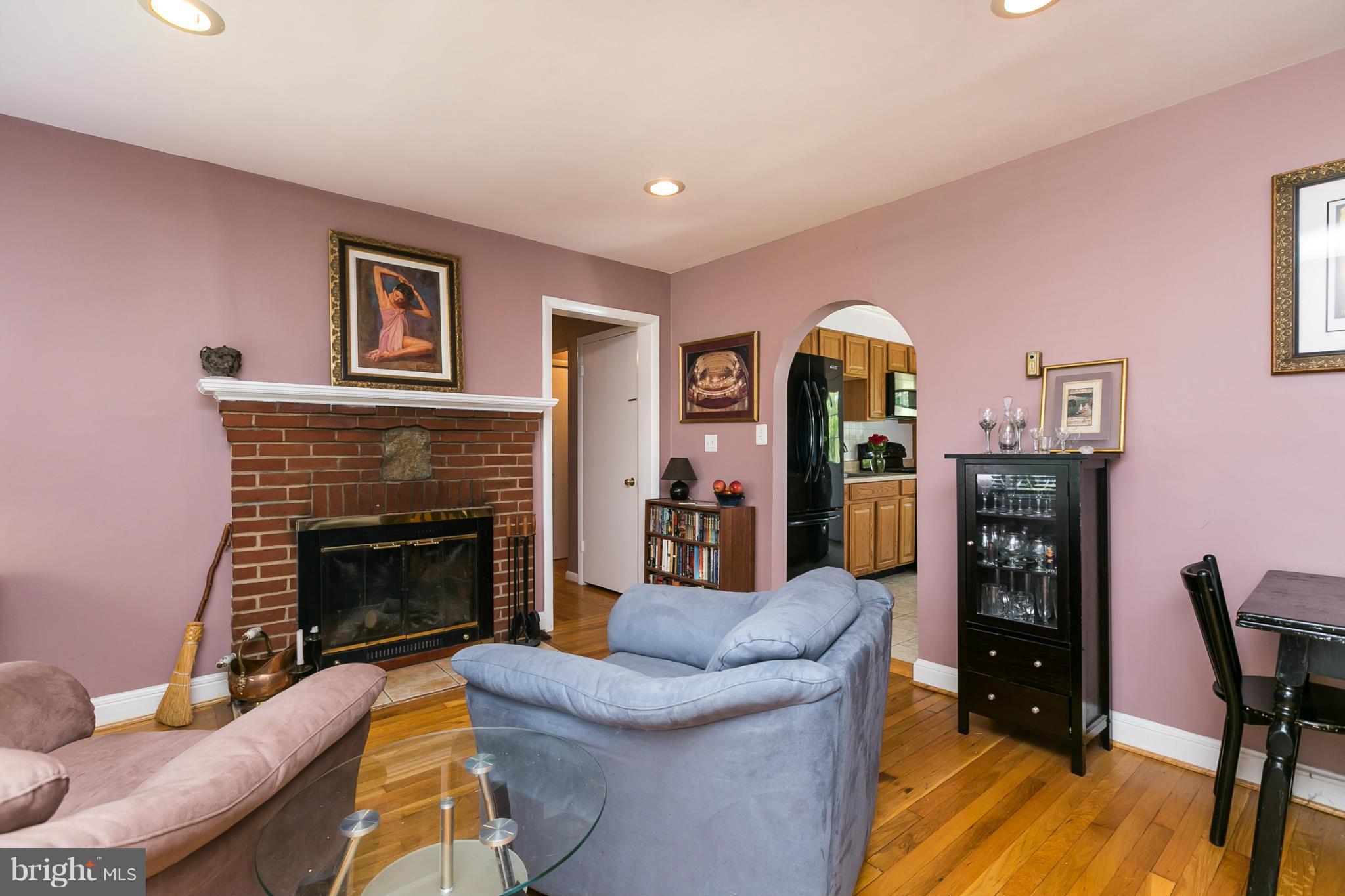 12712 Flack Street Silver Spring, MD 20906 - Photo 6 of 28 a living room with furniture and a fireplace