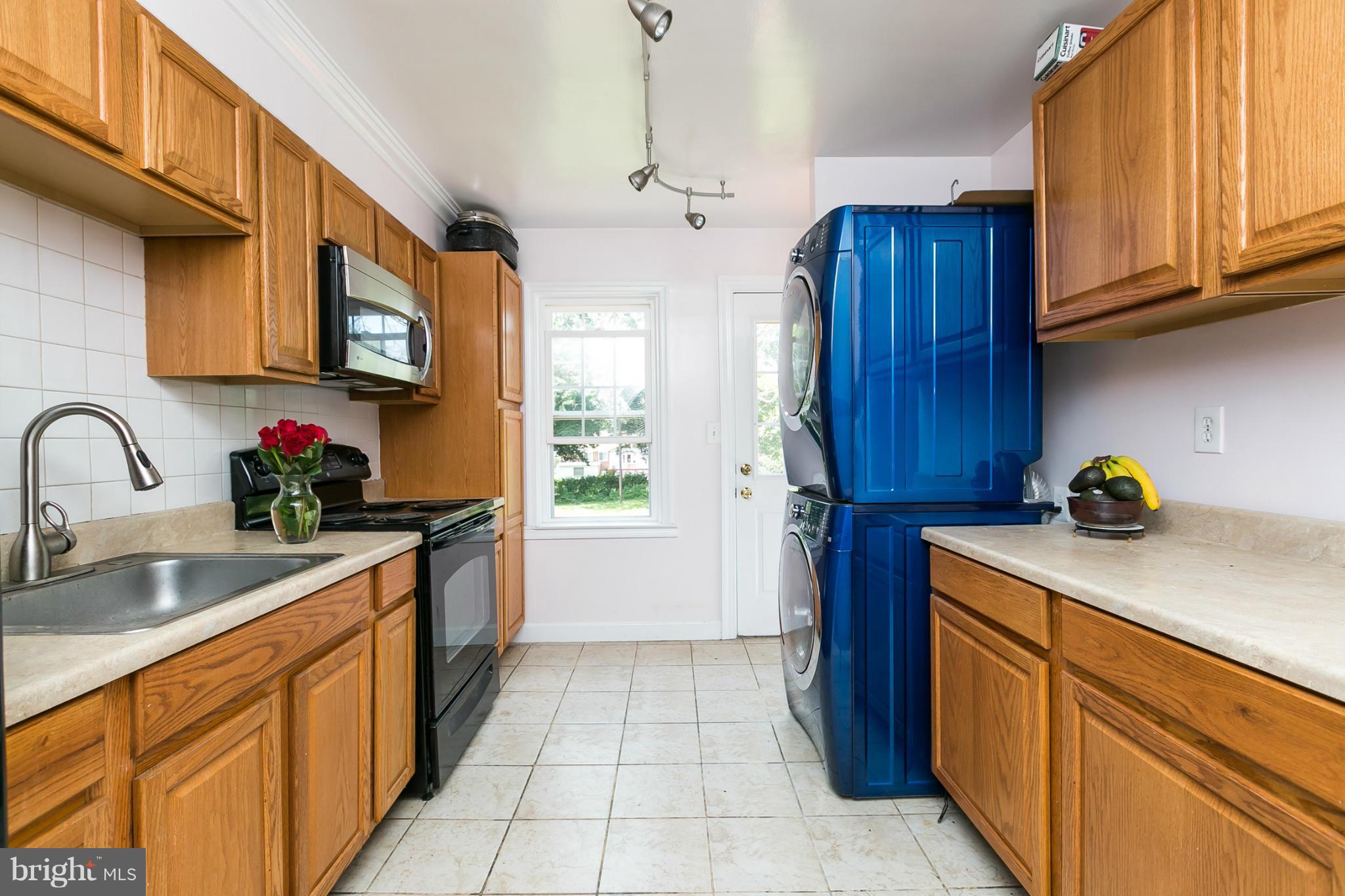 12712 Flack Street Silver Spring, MD 20906 - Photo 9 of 28 a kitchen with stainless steel appliances granite countertop a sink dishwasher stove and cabinets with wooden floor