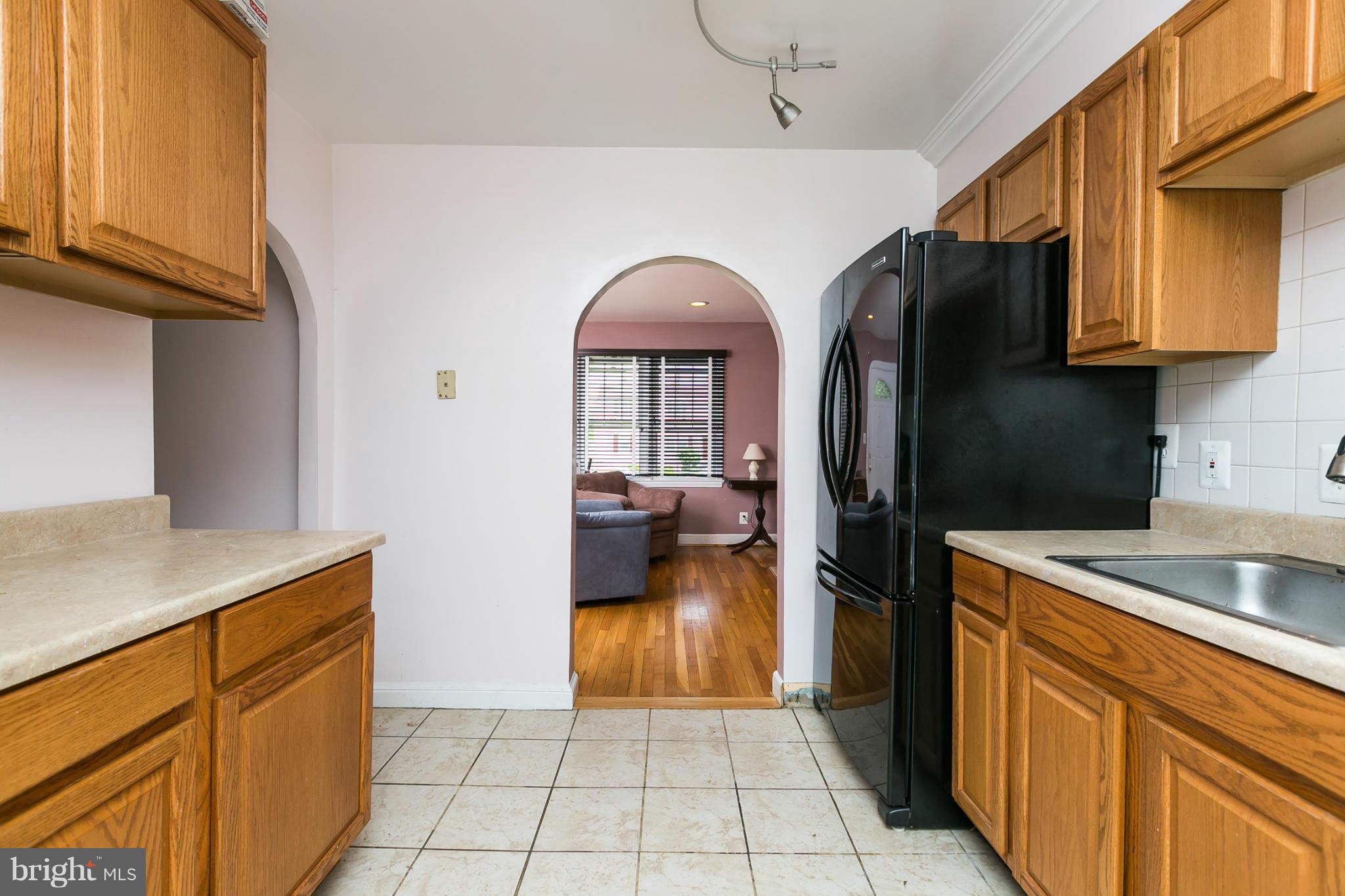 12712 Flack Street Silver Spring, MD 20906 - Photo 10 of 28 a kitchen with a refrigerator and a sink