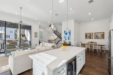 a kitchen island with sink and a wooden floor