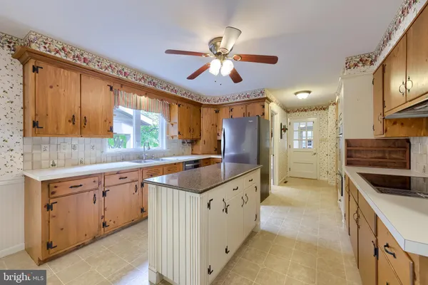 a view of a kitchen and microwave