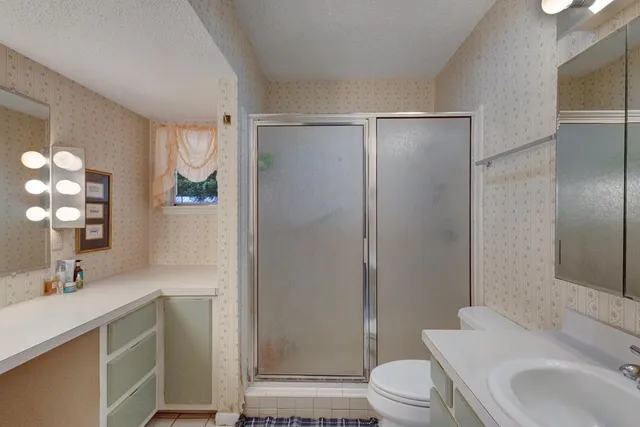 a bathroom with a sink toilet and shower