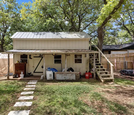 front view of a house with two chairs and a table