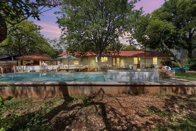 a view of a backyard with sitting area