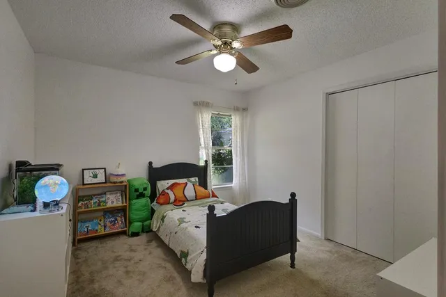a living room with furniture a baby crib and a window