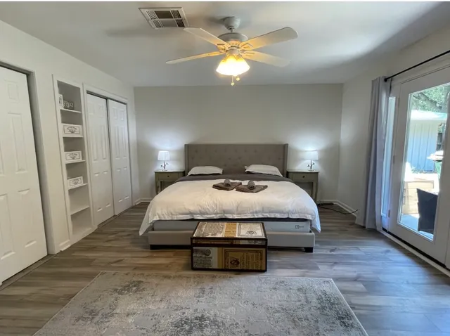 a bedroom with a bed and a chandelier