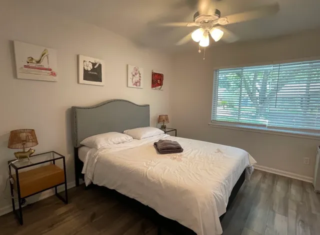 a bedroom with a bed and a window