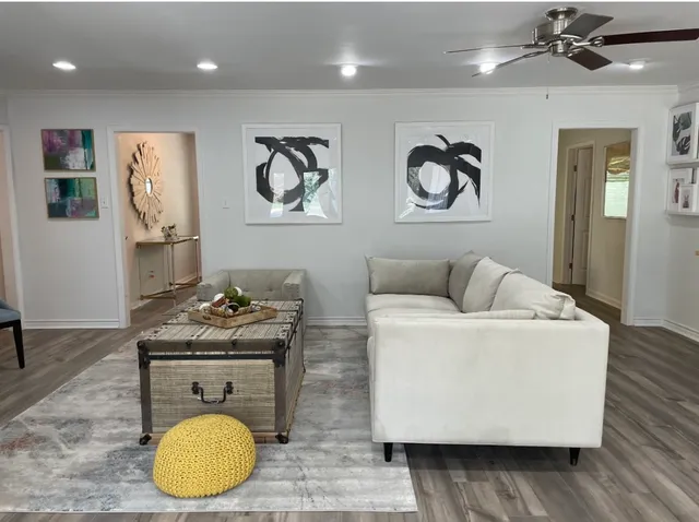a living room with furniture and wooden floor