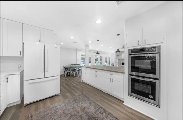 a kitchen with refrigerator cabinets and microwave