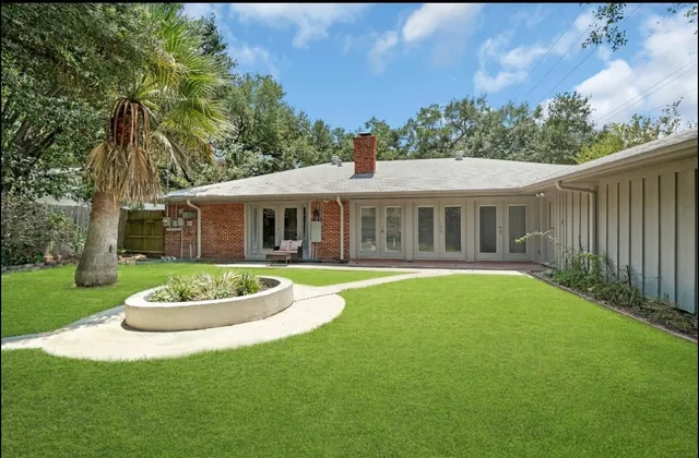 a front view of a house with a garden