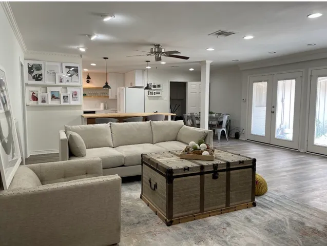 a living room with furniture kitchen and a table