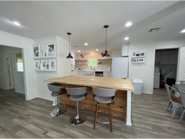 a dining room with furniture and wooden floor