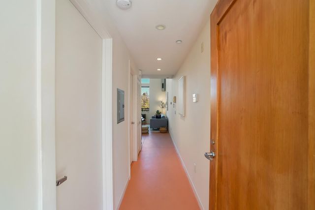a view of a hallway with wooden floor