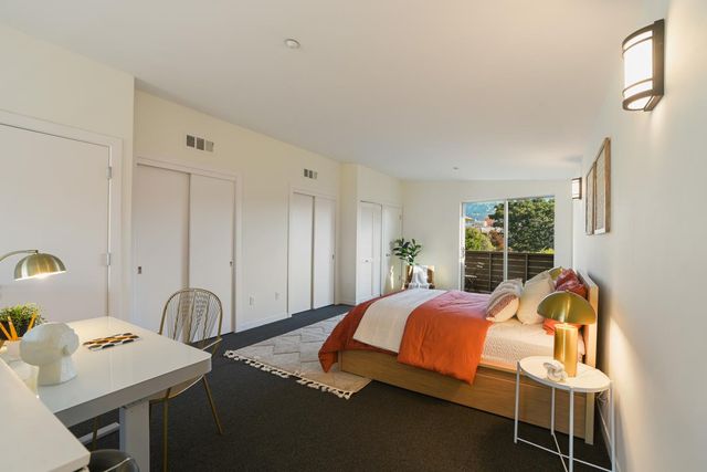 a bedroom with a bed and a table