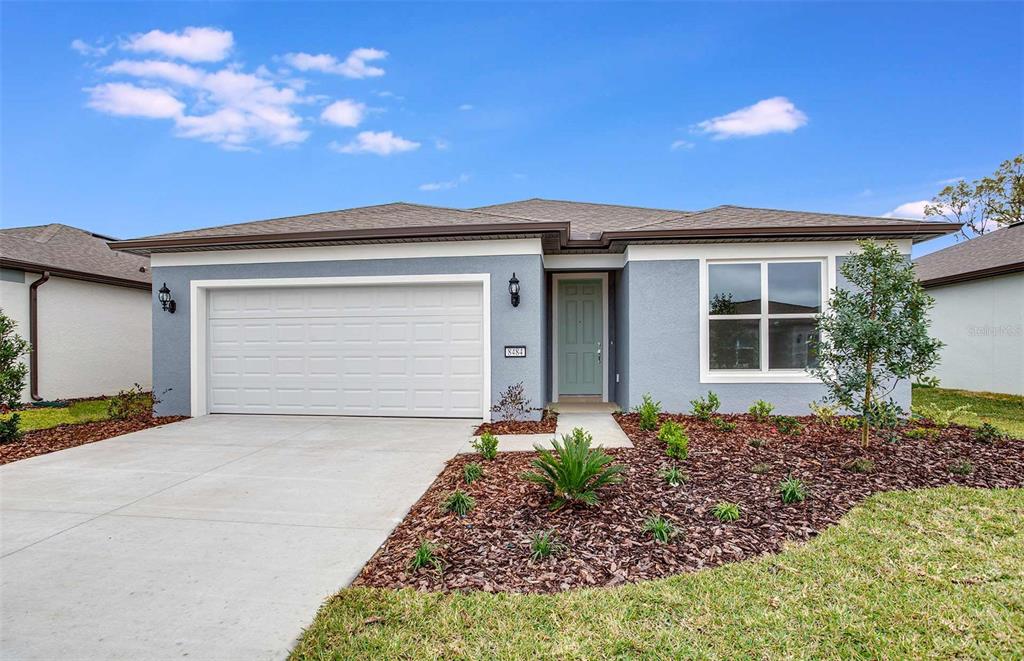 8484 Southwest 52nd Lane Road Ocala, FL 34481 - Photo 1 of 1 a front view of a house with a yard and garage
