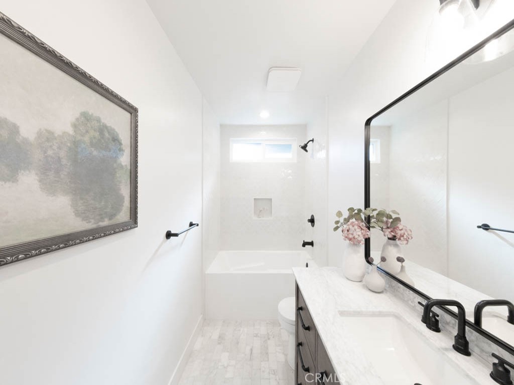 248 Crystal Lane Pasadena, CA 91103 - Photo 12 of 22 a bathroom with a tub sink and mirror