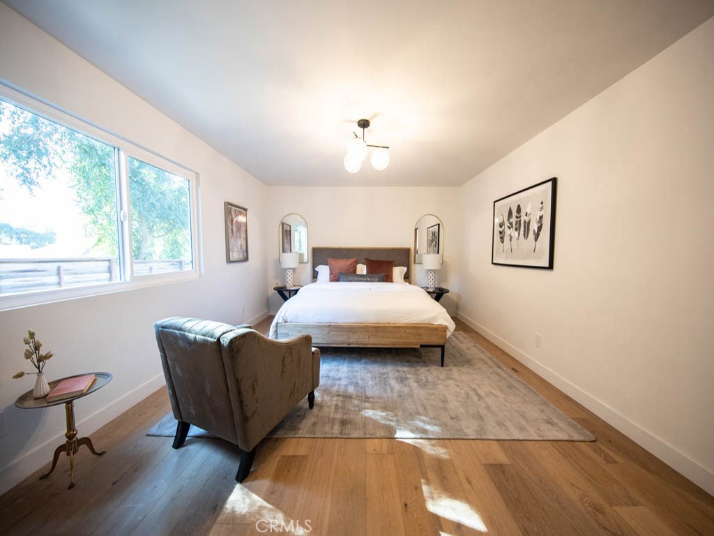 248 Crystal Lane Pasadena, CA 91103 - Photo 13 of 22 a bedroom with a bed and wooden floor
