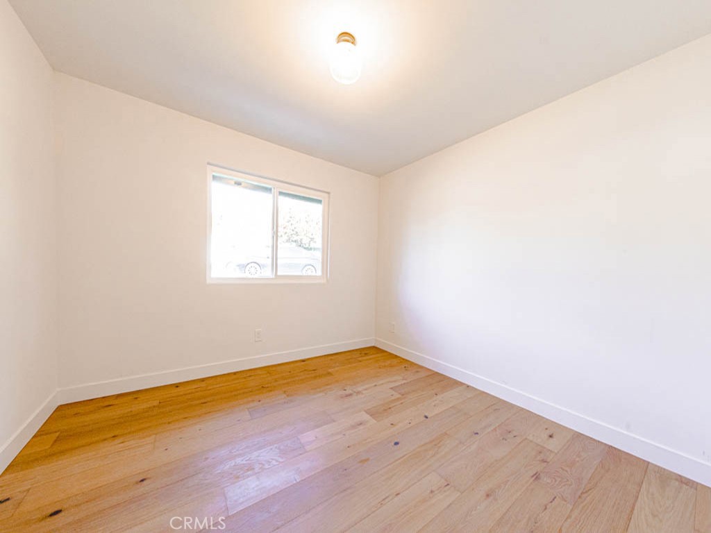 248 Crystal Lane Pasadena, CA 91103 - Photo 15 of 22 an empty room with wooden floor and windows