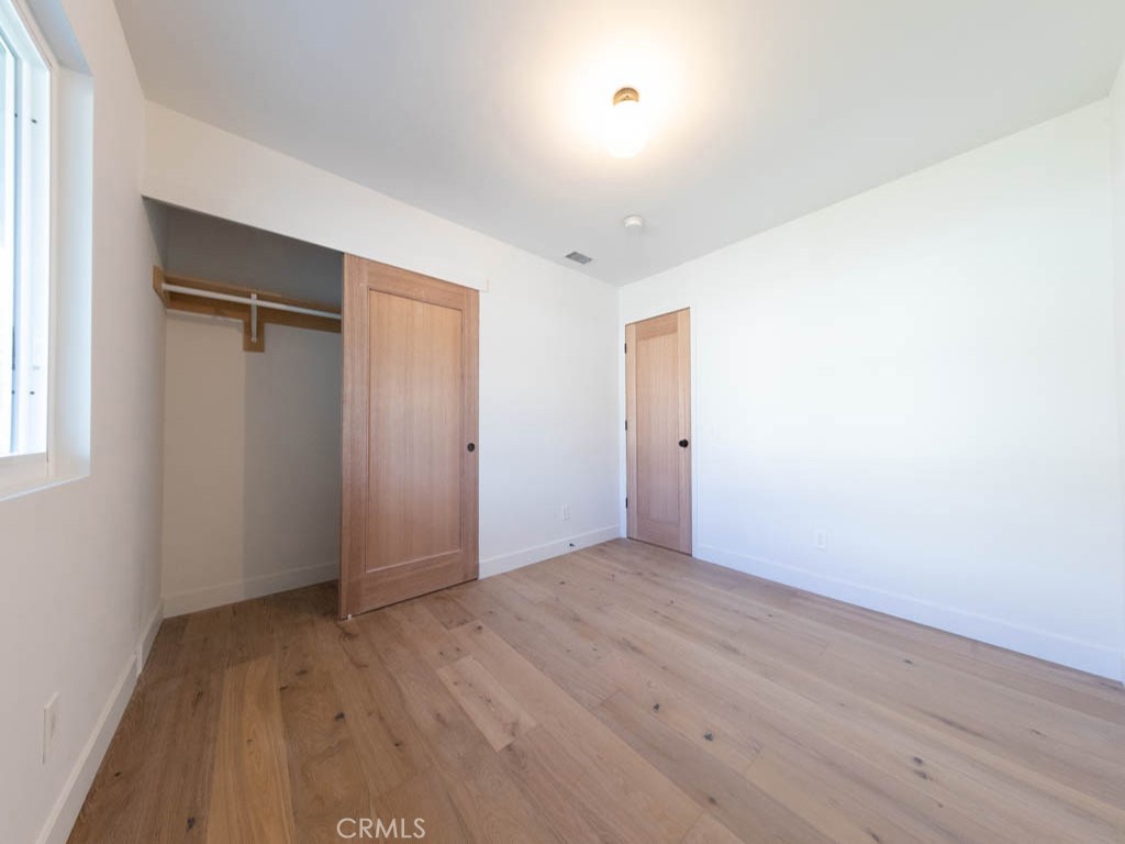 248 Crystal Lane Pasadena, CA 91103 - Photo 18 of 22 an empty room with wooden floor and closet