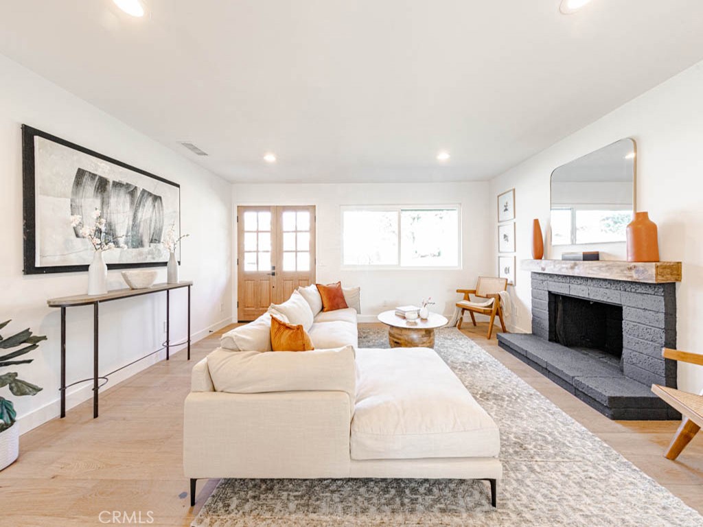 248 Crystal Lane Pasadena, CA 91103 - Photo 3 of 22 a living room with furniture a fireplace and a flat screen tv