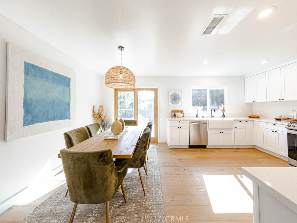 248 Crystal Lane Pasadena, CA 91103 - Photo 5 of 22 a living room with furniture a dining table and a chandelier