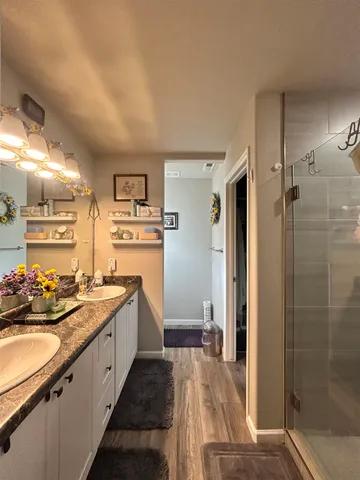 a large kitchen with a sink and refrigerator