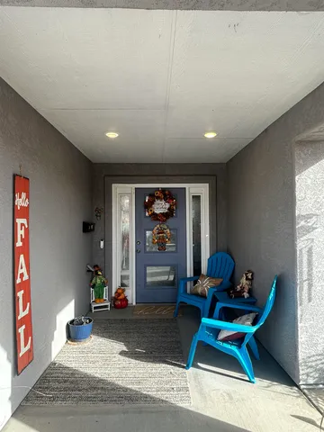a living room with furniture a window and a potted plant