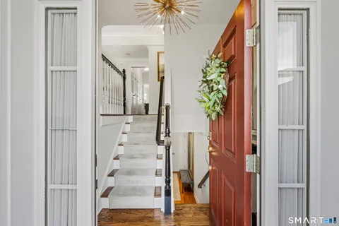 a view of entryway with wooden floor and chandelier
