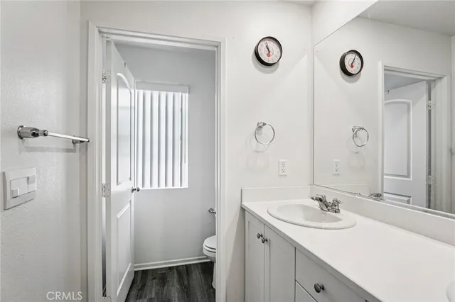 a bathroom with a sink and mirror with toilet