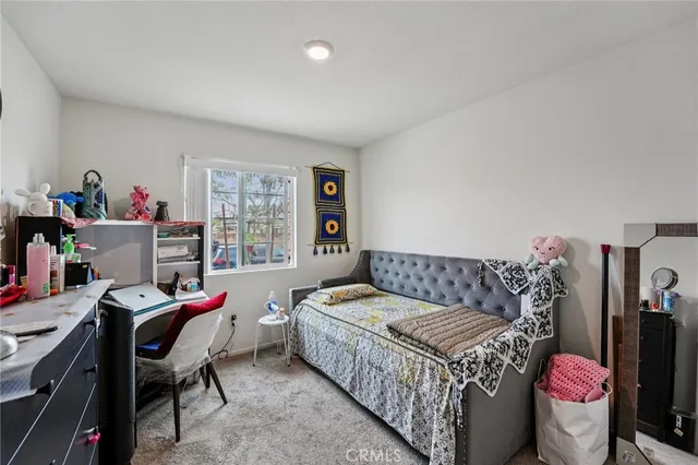 a bedroom with a bed and a desk