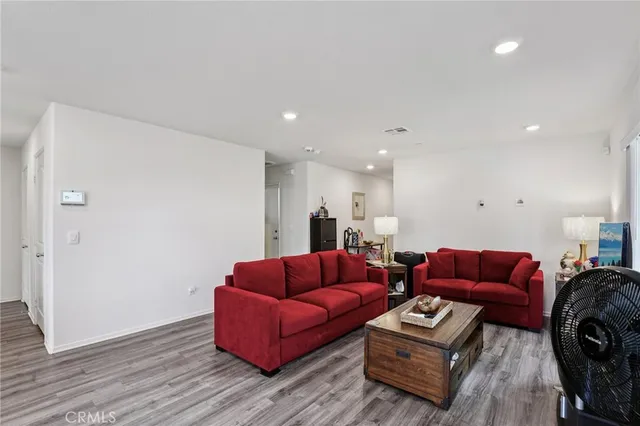 a living room with furniture a couch and a potted plant