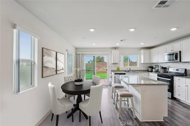 a view of a dining room with furniture window and outside view