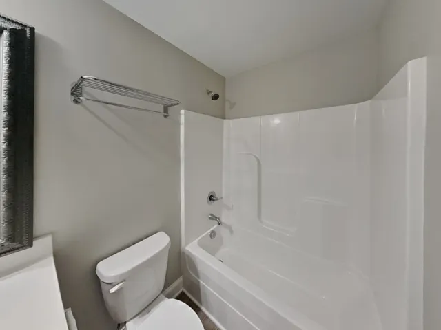 a bathroom with a toilet and a bathtub