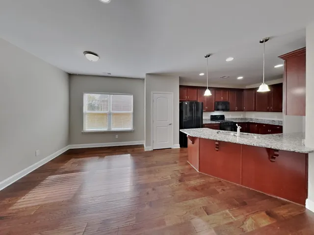 a view of kitchen with stainless steel appliances granite countertop refrigerator sink and stove