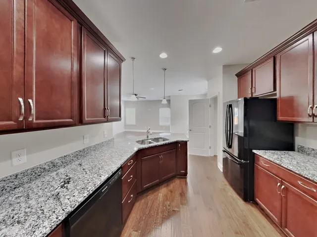 a kitchen with granite countertop stainless steel appliances and sink