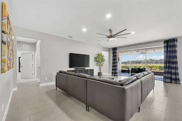 a kitchen with granite countertop kitchen island stainless steel appliances a sink stove and refrigerator