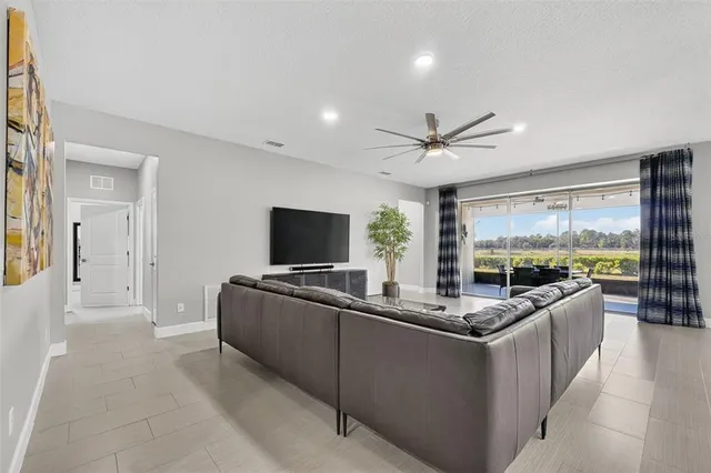 a kitchen with granite countertop kitchen island stainless steel appliances a sink stove and refrigerator