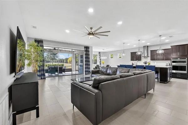 a kitchen with stainless steel appliances granite countertop a sink a stove and a wooden floors