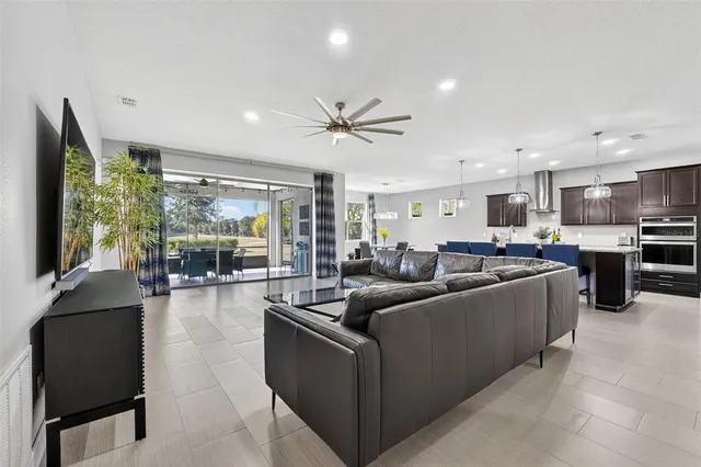 a kitchen with stainless steel appliances granite countertop a sink a stove and a wooden floors