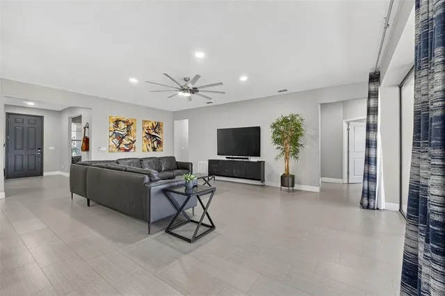 a living room with furniture and a chandelier