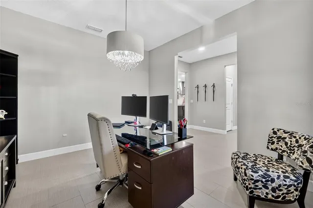 an aerial view of a house with a yard and a large tree