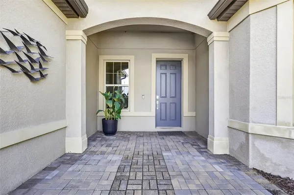 a living room with furniture a flat screen tv and a large window