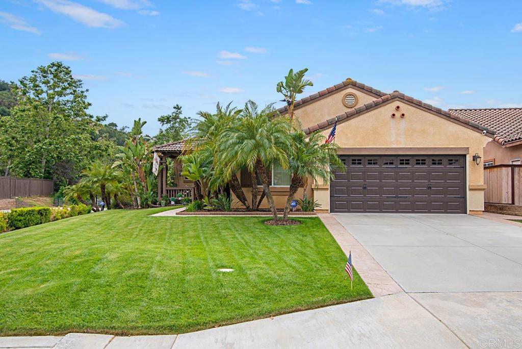 a front view of a house with a garden