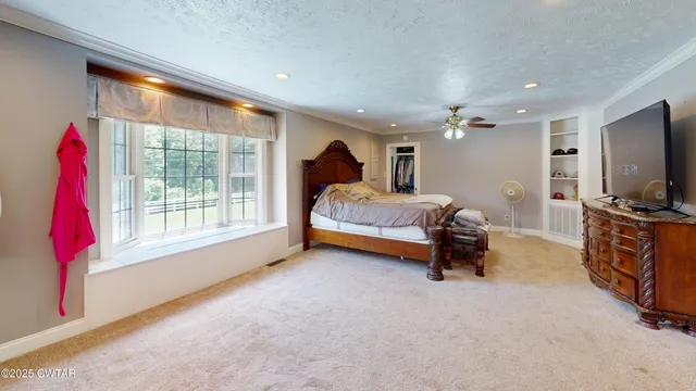 a bedroom with furniture and a flat screen tv