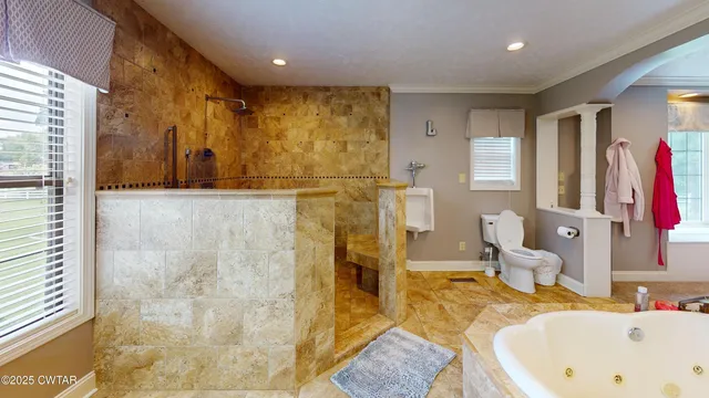 a bathroom with a tub sink and mirror