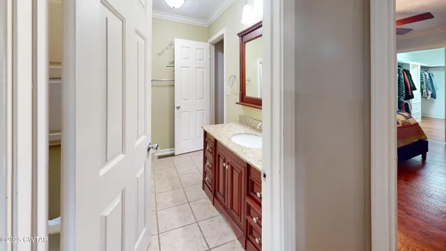 a spacious bathroom with a double vanity sink and a mirror