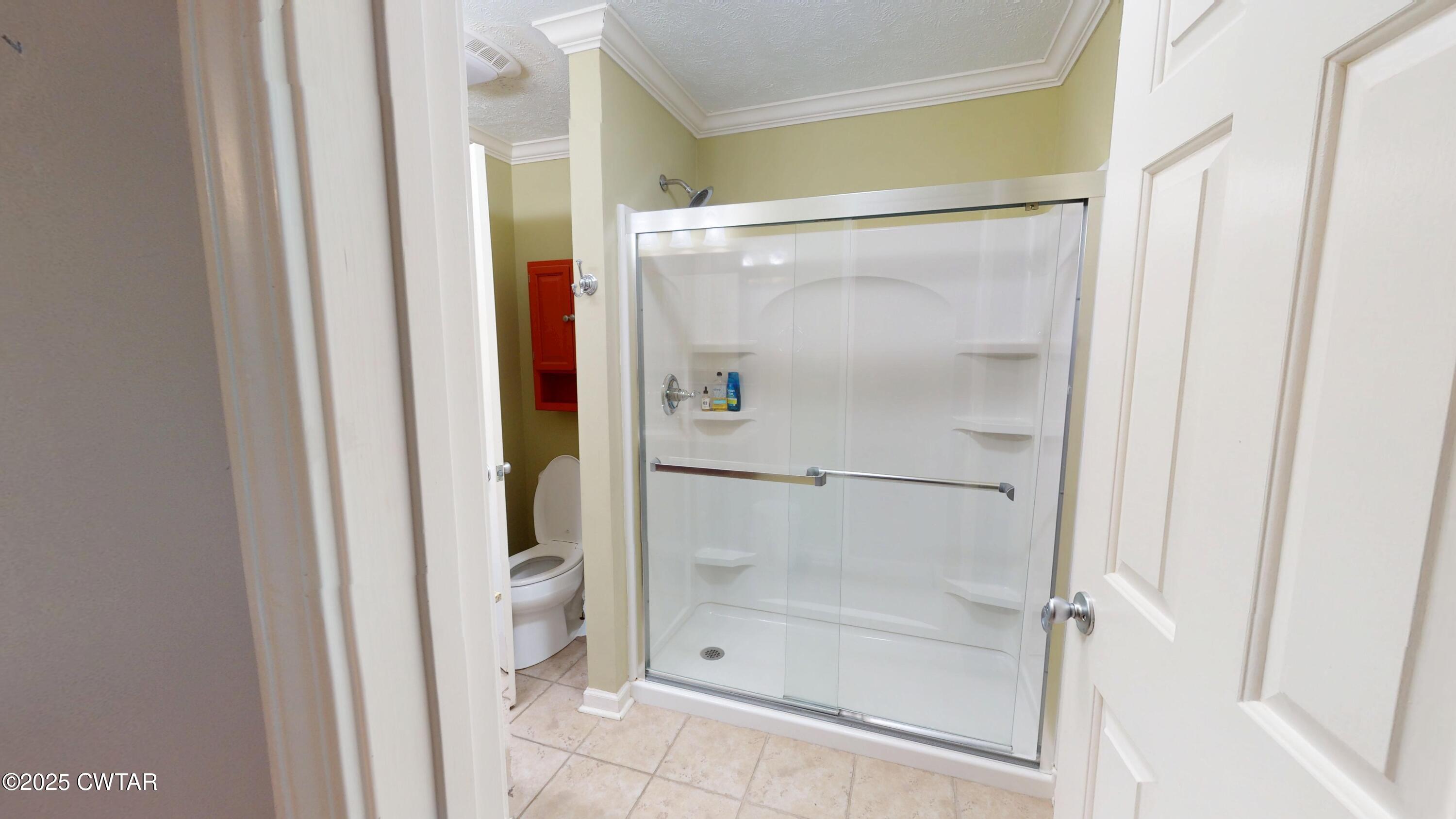 783 Sharps Ferry Road Newbern, TN 38059 - Photo 21 of 50 a bathroom with a glass shower door and a glass door